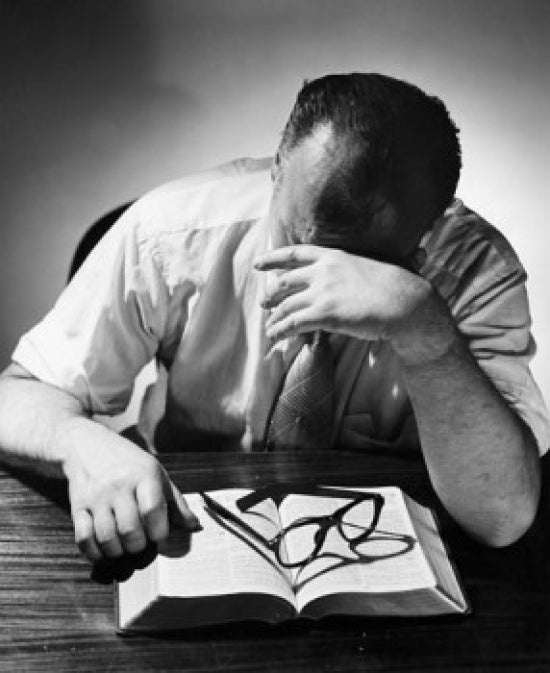 Contemplative Man Poster Print - A man with hand on forehead in deep thought