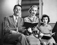Mid adult couple singing with their daughter poster print