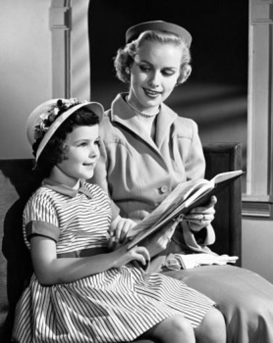 Mid adult woman and daughter holding a Bible poster print.