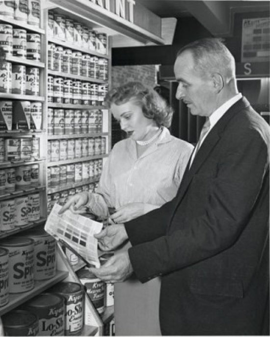 Poster print of a mature couple holding a color swatch in a paint store.