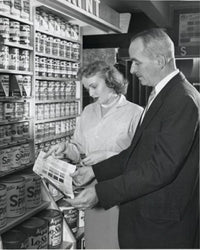 Poster print of a mature couple holding a color swatch in a paint store.