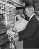 Poster print of a mature couple holding a color swatch in a paint store.