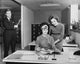 Poster print of two businesswomen reading a file and a businessman at an office door.