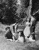 Three Teenage Couples on Picnic Poster Print showcasing youthful joy.