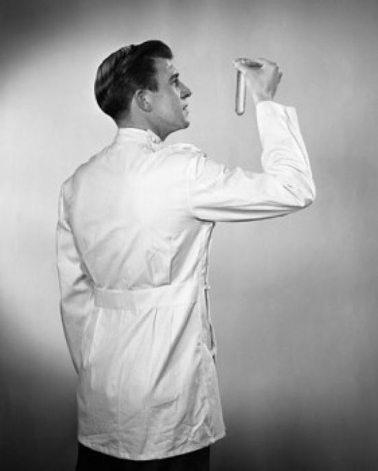 Rear view of a male scientist examining a test tube poster print