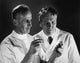 Poster print featuring two scientists analyzing chemicals in test tubes.