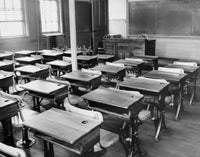 Empty Desks in a Classroom Poster Print showcasing an empty classroom setting.