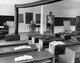 Empty Desks in a Classroom Poster Print showcasing a serene classroom setting.