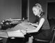 Side profile of a businesswoman typing on an accounting typewriter poster print.