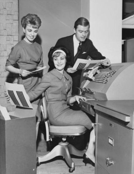 Poster print featuring two businesswomen and a businessman working on an accounting machine.