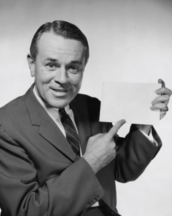 Close-up of businessman pointing to blank placard poster print.