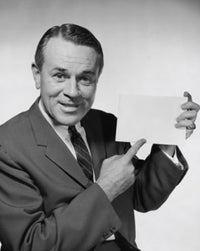 Close-up of businessman pointing to blank placard poster print.