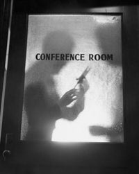 Silhouette of two business executives behind a glass door poster print.