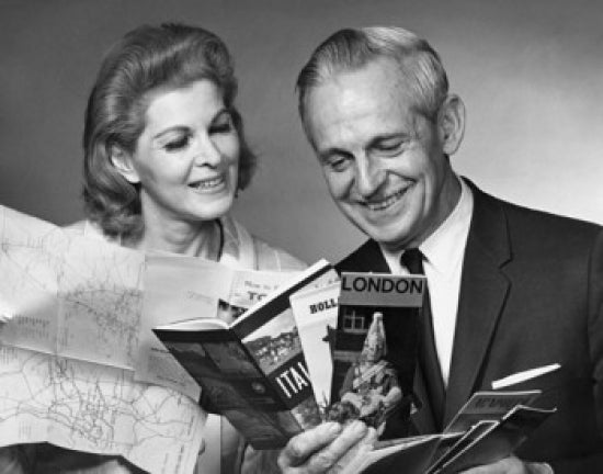 Close-up poster print of a senior couple looking at brochures.