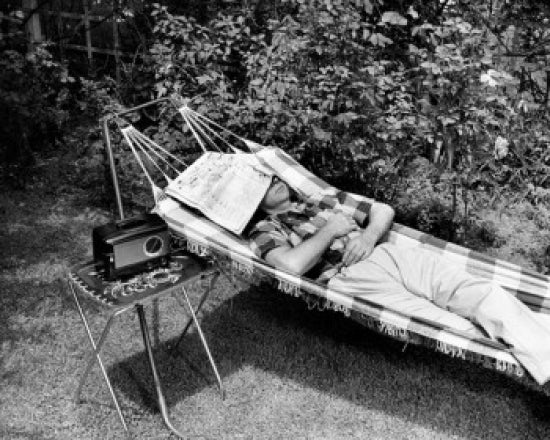 Poster print of a man relaxing in a hammock listening to a radio.