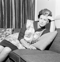 Housewife with Fatigued Expression Leaning on Sofa Poster Print