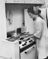 Young woman working in a kitchen poster print.