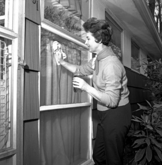 Woman cleaning window poster print on heavy stock paper.
