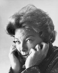 Close-up poster print of a mid adult woman with snowflakes in her hair and clothes.