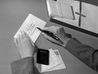 Hands writing a letter poster print depicting the art of communication.