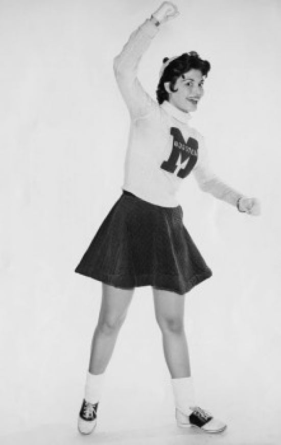 Portrait of a smiling female cheerleader standing, poster print.