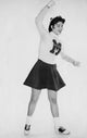 Portrait of a smiling female cheerleader standing, poster print.
