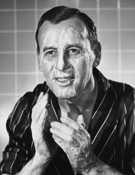 Close-up of a mature man applying soap to his face poster print