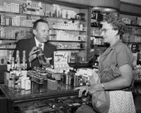 Salesman showing product to woman in store poster print.