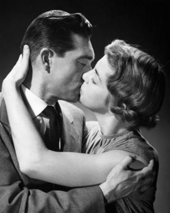 Close-up poster print of a young couple kissing, capturing a romantic moment.