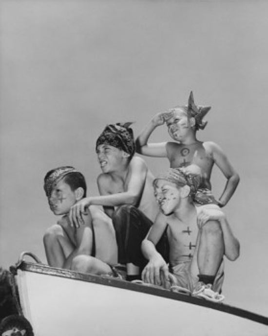 Four boys sitting on a boat pretending to be pirates poster print