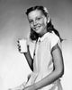Cheerful girl holding a glass of milk poster print