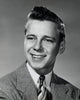 Close-up of a teenage boy smiling poster print showcasing joy and positivity.