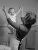 Mother Playing with Baby Girl in Bathroom Poster Print