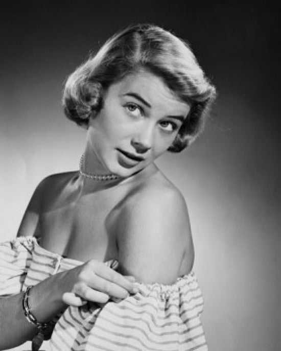 Studio shot poster print of a young woman adjusting her dress