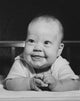 Close-up poster print of a smiling baby in a crib