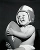 Close-up of a baby boy holding a football, charming poster print.