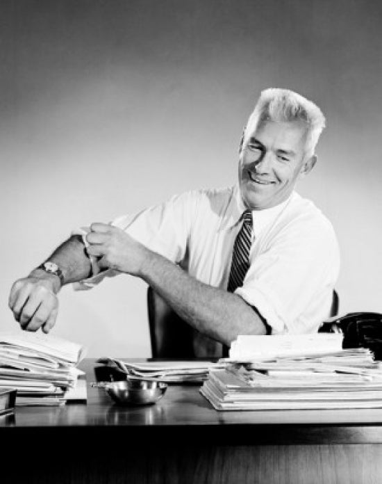 Portrait of businessman at desk preparing to work poster print