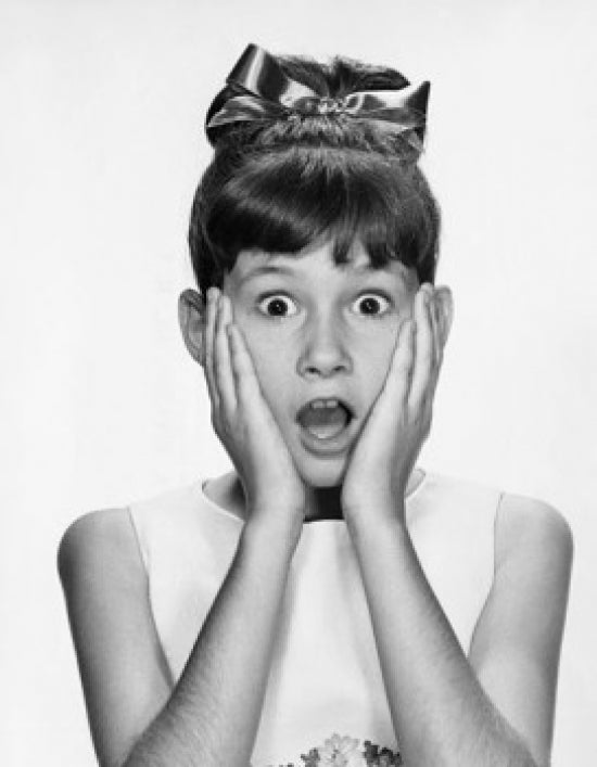 Portrait of a girl looking surprised poster print