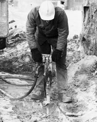 Worker Using a Pneumatic Drill Poster Print showcasing industrial energy.