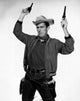 Cowboy Holding Two Pistols Poster Print showcasing Wild West theme.