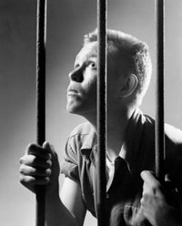 Male prisoner holding prison bars in a prison cell poster print.