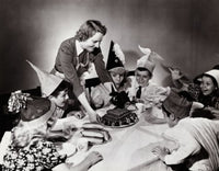 Young woman serving hot dogs to children at a party poster print