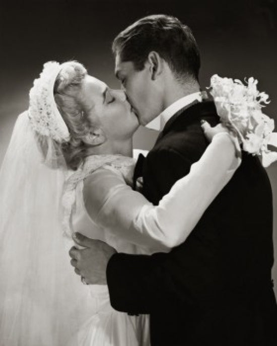 Side profile of a newlywed couple kissing poster print
