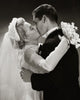 Side profile of a newlywed couple kissing poster print