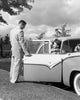Young man opening car door for teenage girl poster print