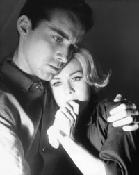 Close-up of a young man embracing a young woman looking serious poster print