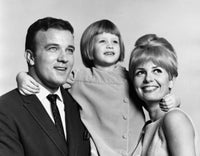 Close-up of a mid adult couple smiling with their daughter poster print.