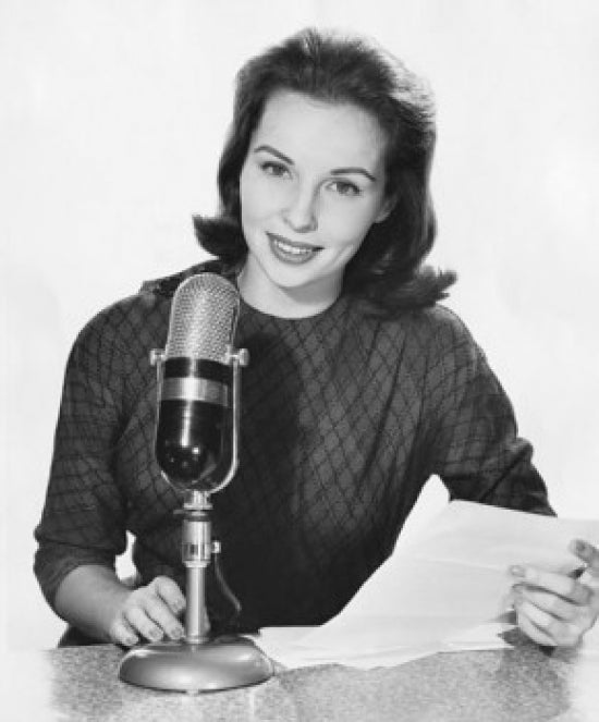 Portrait of a female newscaster speaking into a microphone poster print.