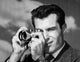 Close-up poster print of a mid adult man taking a photograph.
