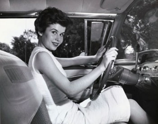 Poster print of a smiling young woman sitting in a car